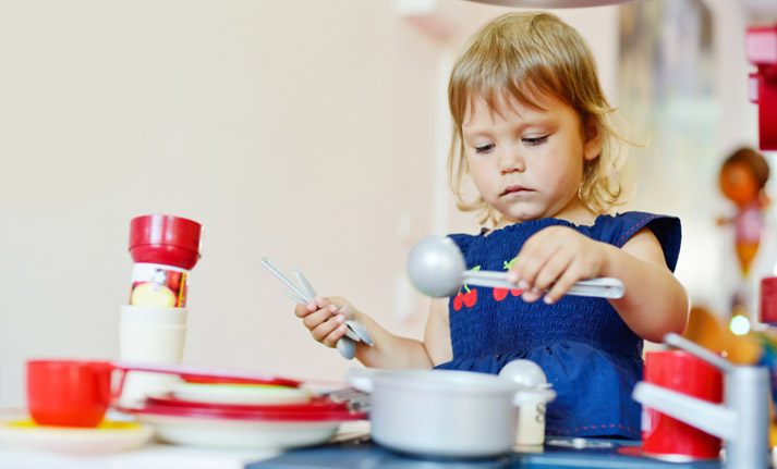 young girl pretending to cook