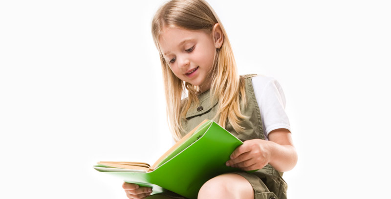 young happy girl reading large green book